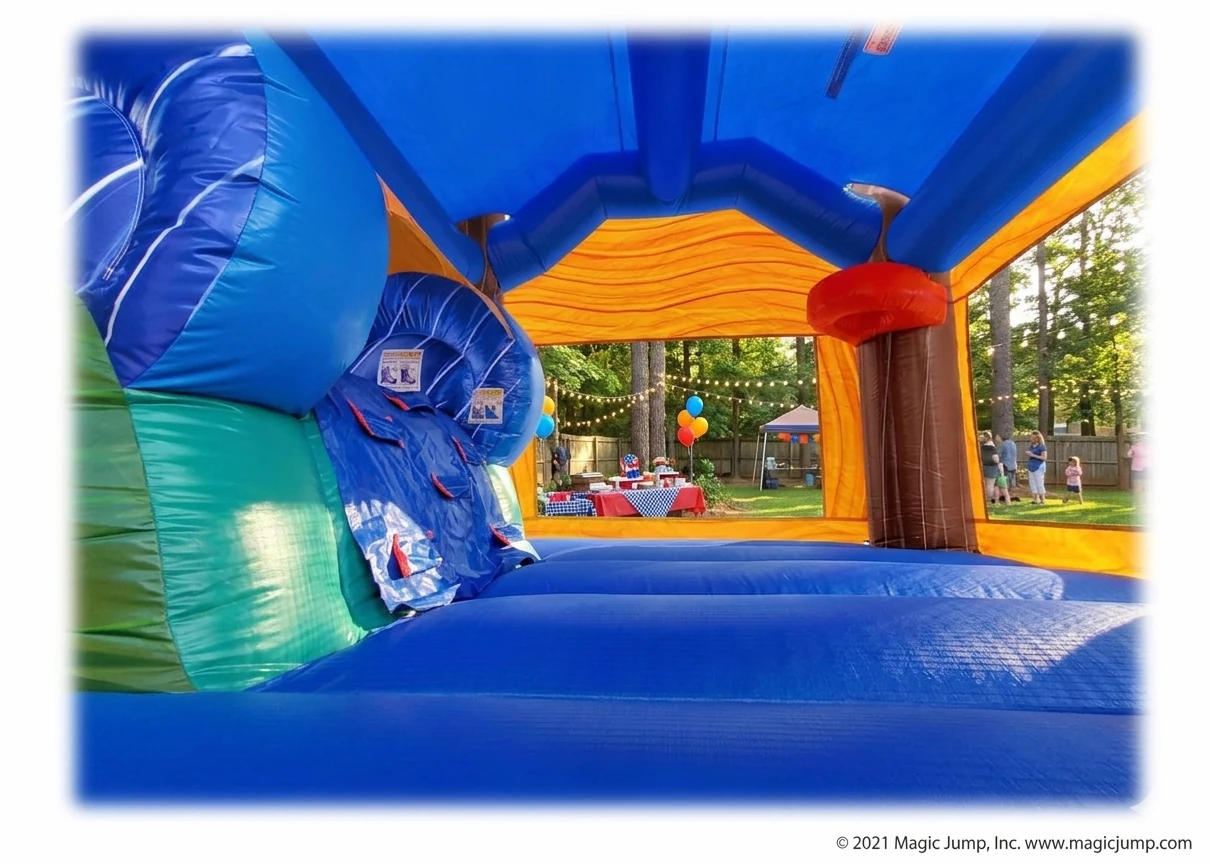 Interior view of the jumping area, basketball hoop, and climbing wall inside the Tropical Breeze bounce house rental set up for a backyard party in Holly Springs, NC.