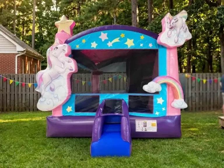 Magical Unicorn Bounce House with Slide rental in a residential backyard in Holly Springs.