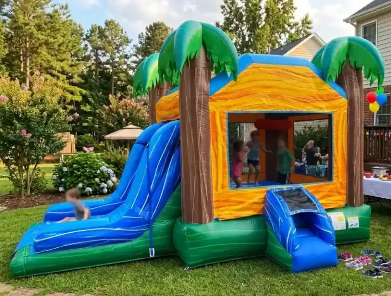 Kids playing in a Tropical Breeze bounce house and water slide combo rental set up in a backyard in Holly Springs, NC.
